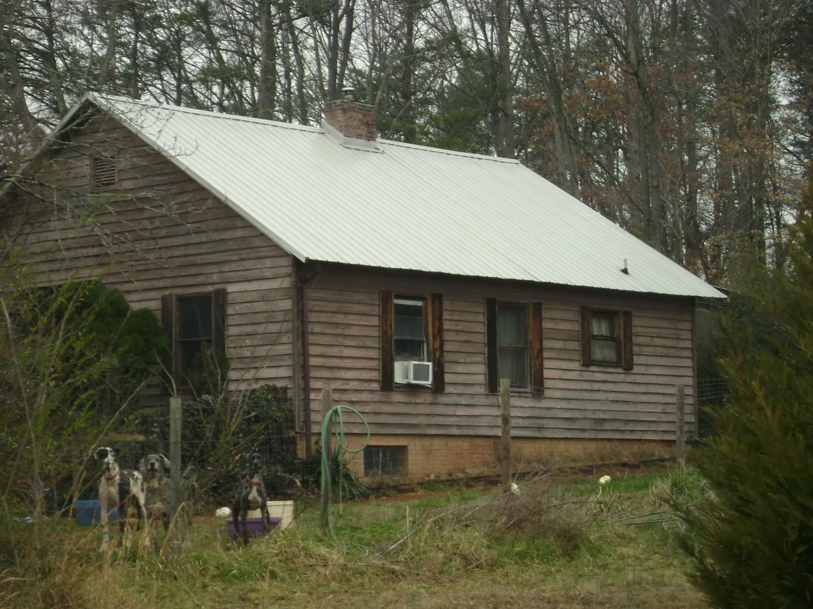 White metal roof on an old wood sided farmhouse, from a Metal Roof Installation job in Masontown