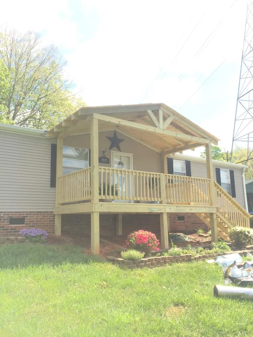 New gabled porch roof and deck railing added to a ranch home in Masontown